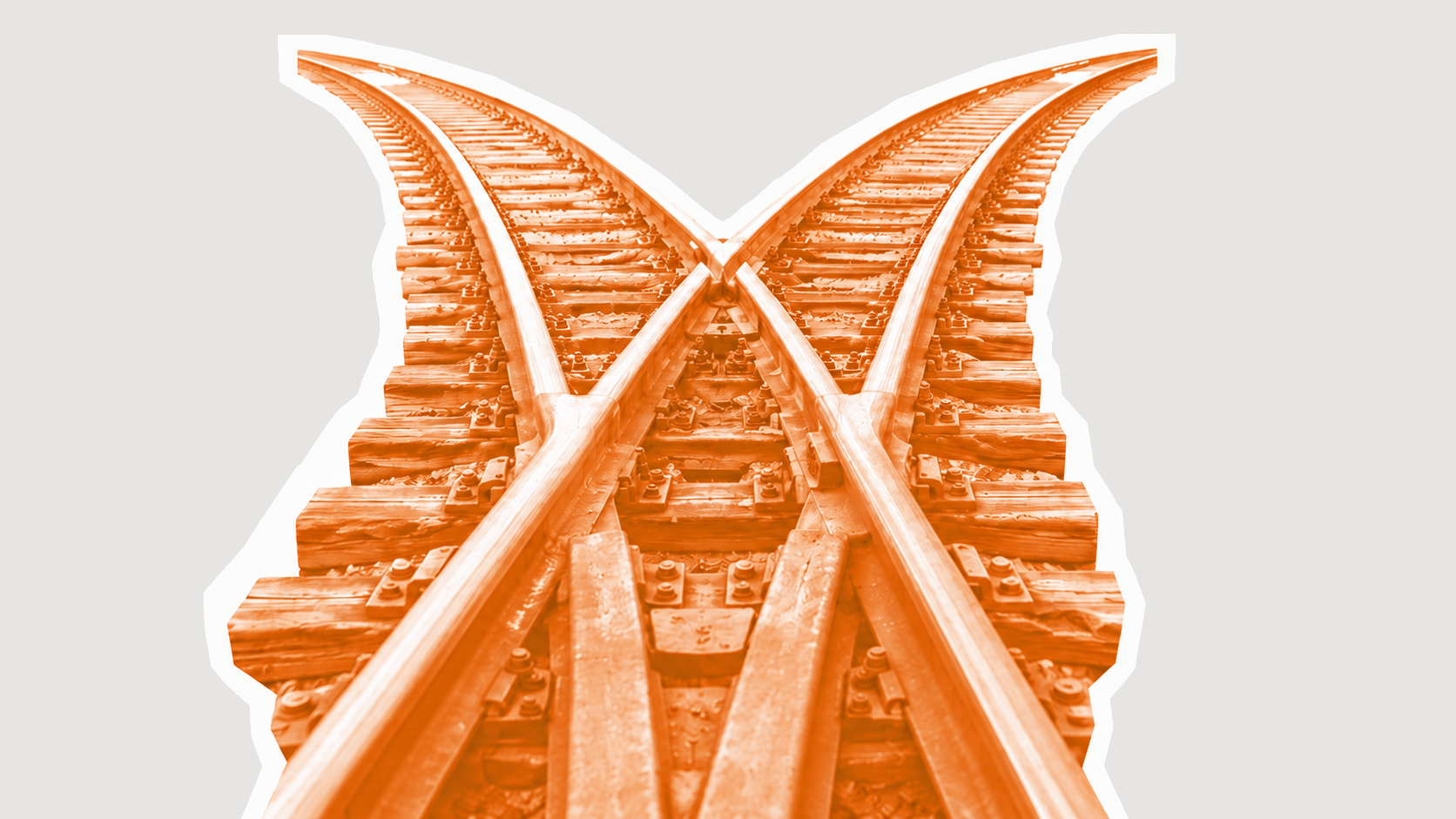 Orange railroad tracks splitting at a junction into two paths.